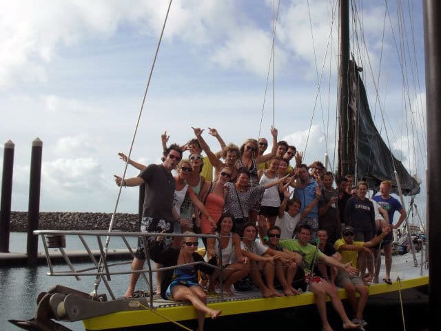 Guest in a group photo on the bow of Apollo