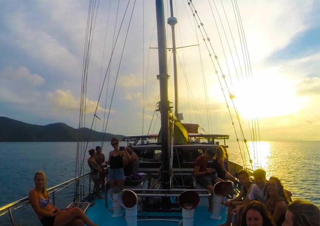 Habibi-Whitsundays-on-anchor-with-a-sunset-behind-them
