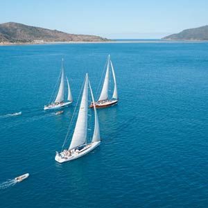 Three Prosail boats sailing towards the Whitsunday Islands