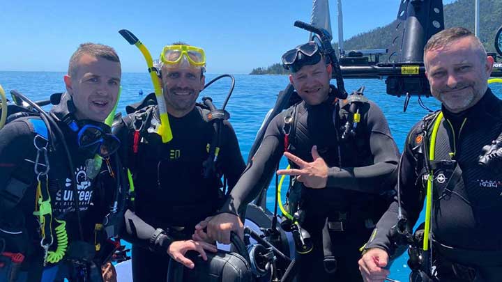 scuba divers on boat tour from airlie beach